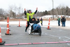 A cyclist navigates through orange cones on a race course during a competitive event.