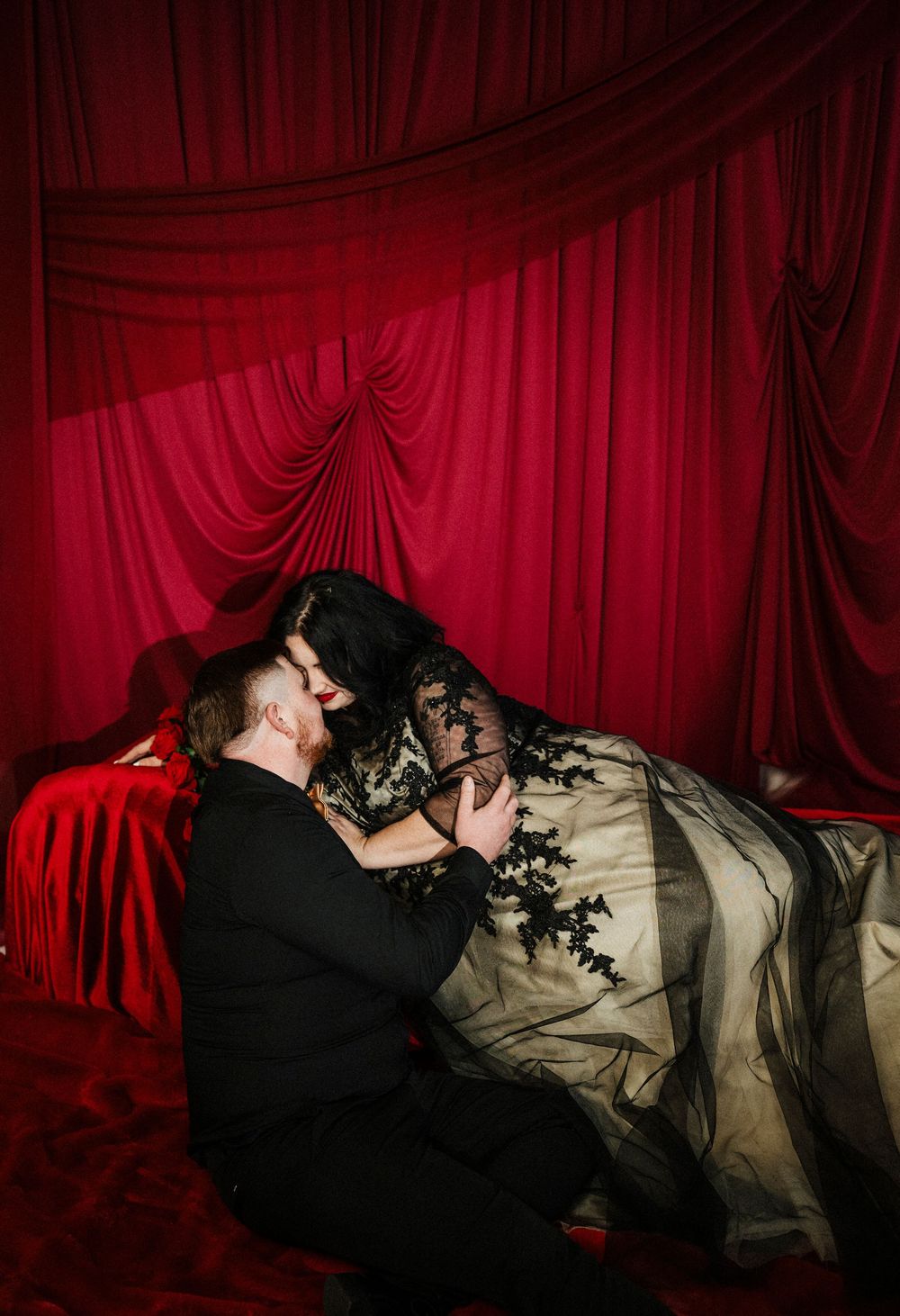 A dramatic series of photos showing a couple embracing against a deep red theater curtain backdrop.