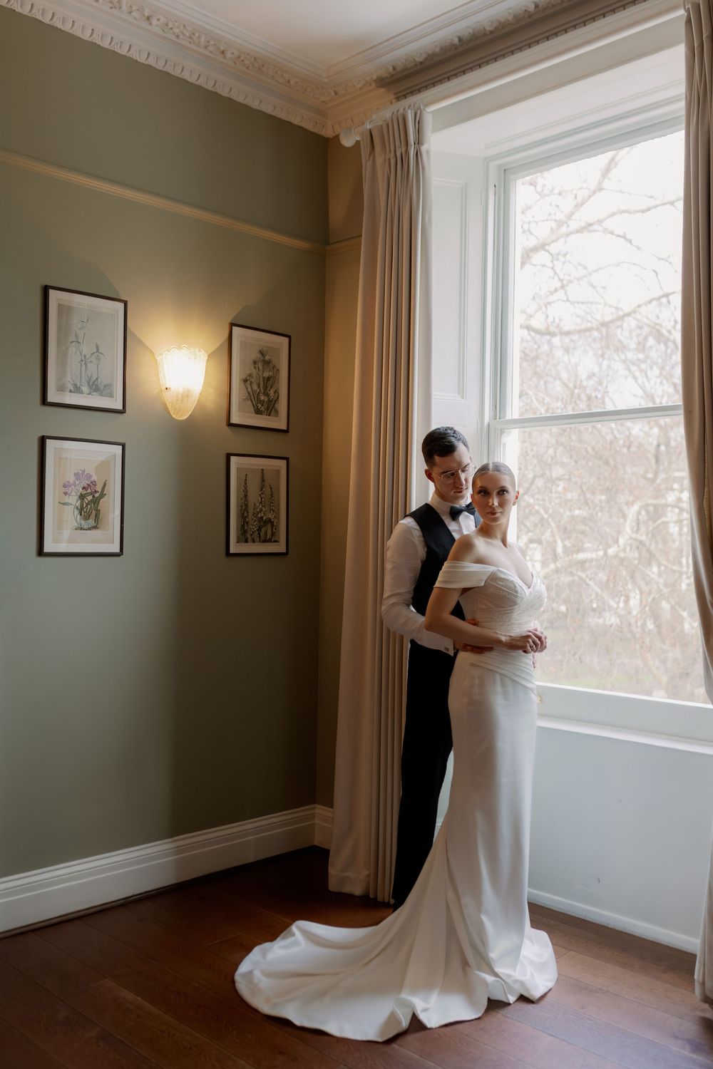 A series of elegant wedding preparation photos showing a flowing white dress in a room with sage green walls and natural light.