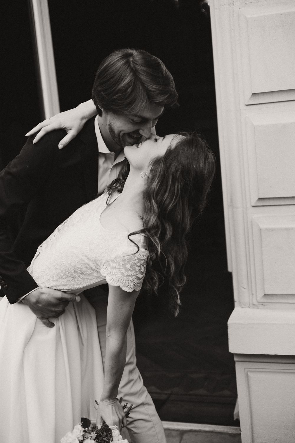 A romantic black and white wedding photo sequence shows tender moments between a couple in elegant attire.