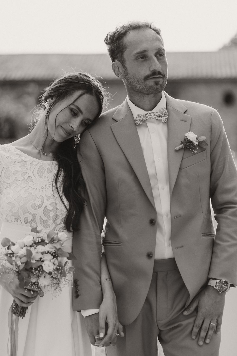 Classic black and white portrait of newlyweds in elegant wedding attire.