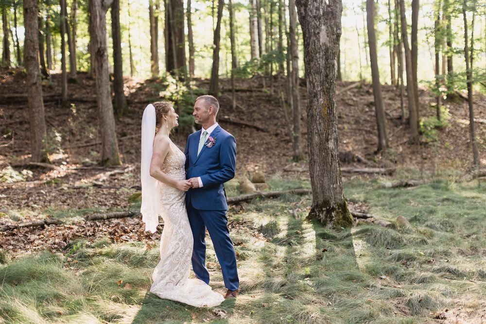 Series of romantic woodland engagement photos showing couple embracing among tall trees in natural forest setting.