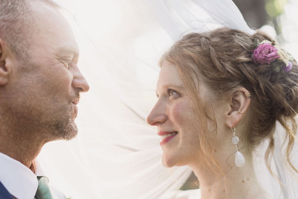 Close-up profile shots of a couple sharing tender moments during their wedding day.