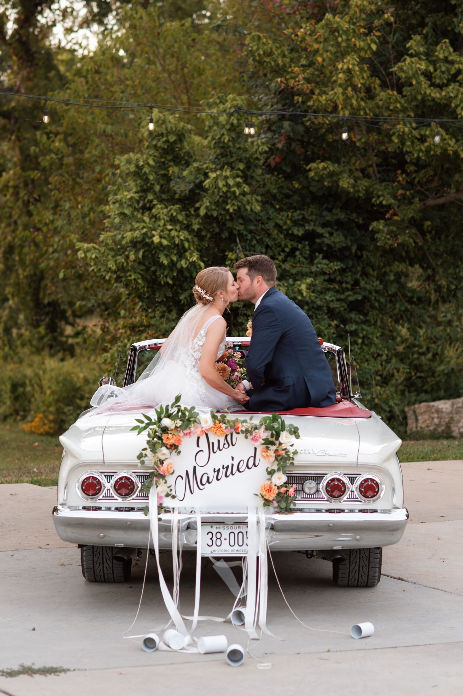 A series of romantic wedding photos showing a couple sitting in a white classic car decorated with 'Just Married' signage.