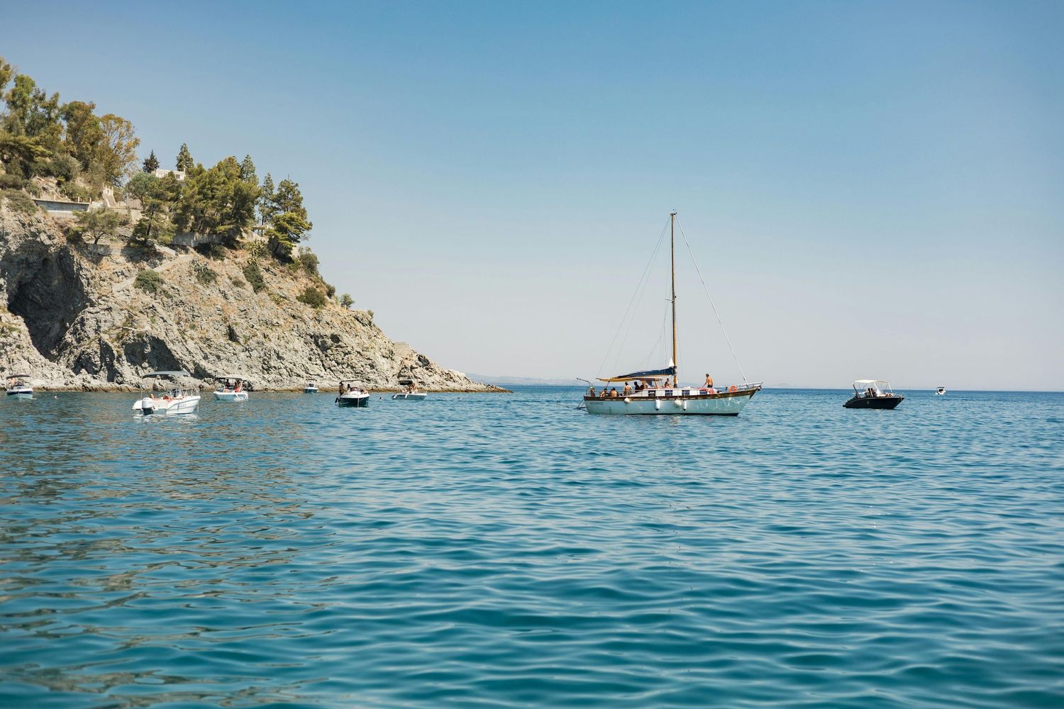 Capo Vaticano coastline with rocky cliffs and boats on the Tyrrhenian Sea, Calabria, Italy