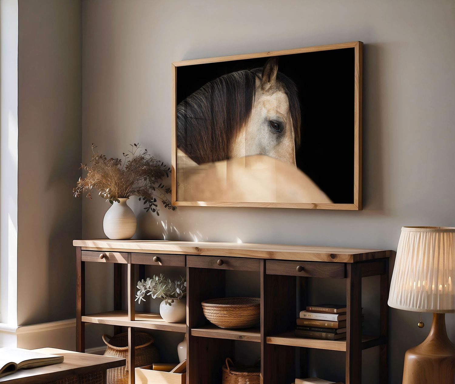 Large framed photograph of a horse's face hangs above a wooden storage unit with decorative vases and lamp in a modern room.