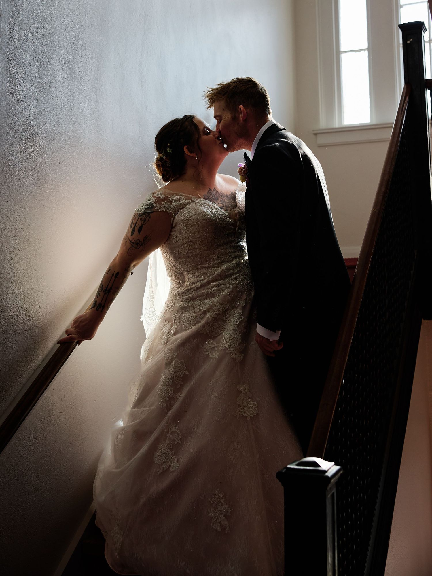 Romantic garden moment captured through foliage during a wedding photoshoot.