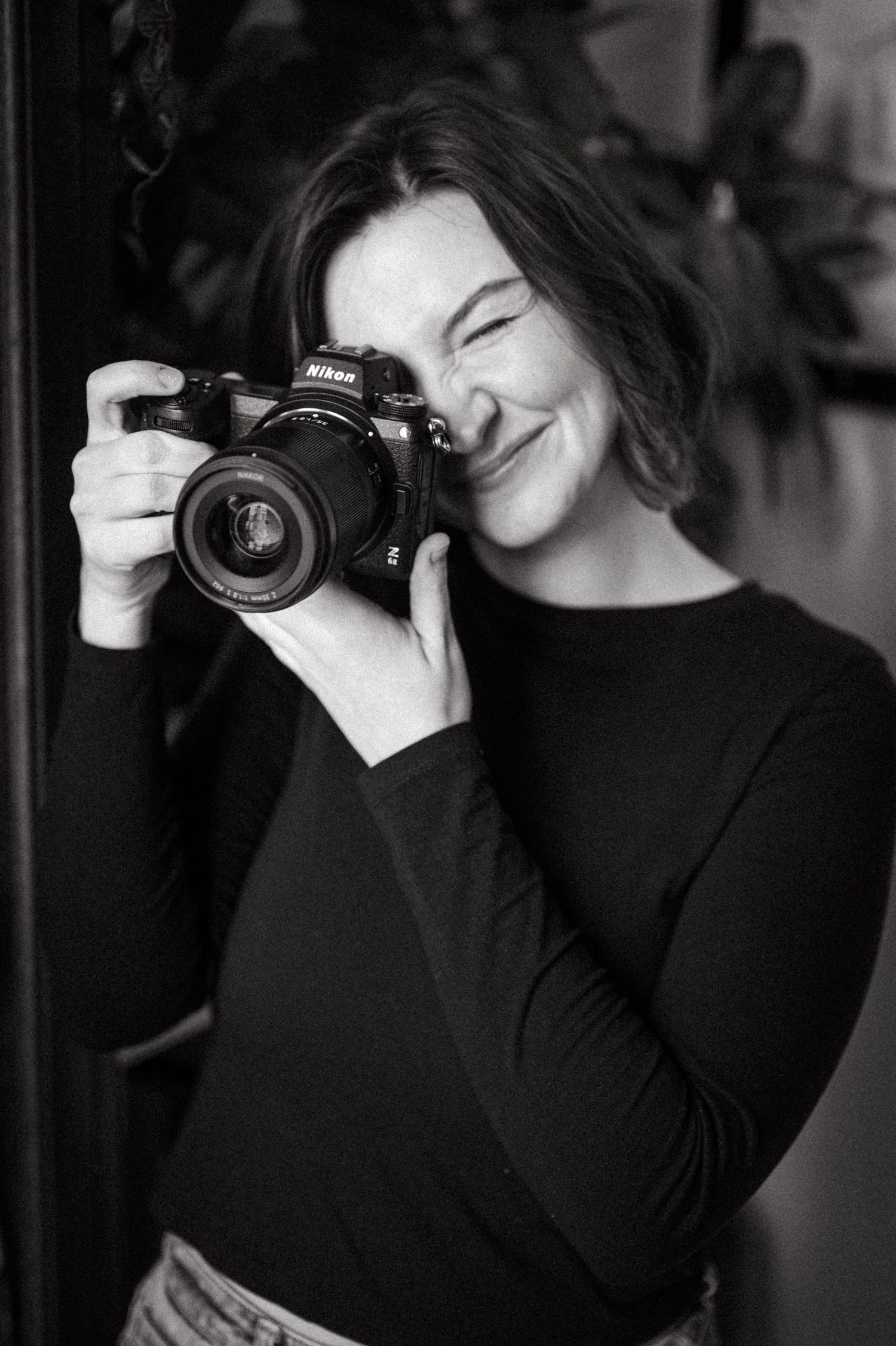 Photographer with a vintage camera taking pictures in black and white composition.