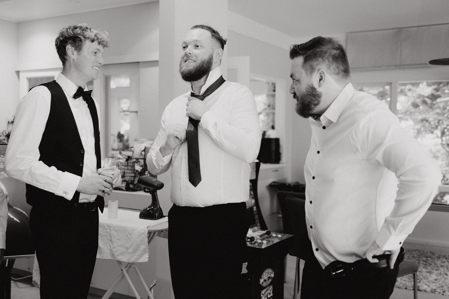 The Groom and the boys share a candid moment while getting ready for the wedding, captured by Apertured Media Auckland Wedding Photographer.