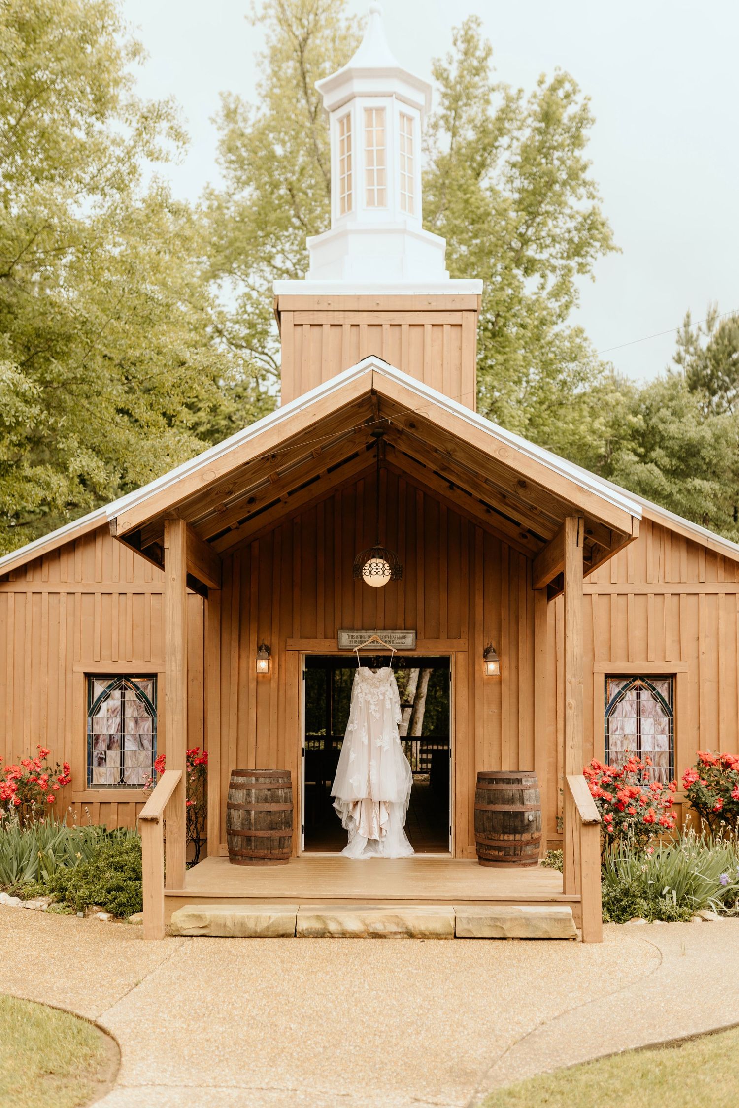 photograph of a wedding dress hanging at the Barn at Big oak in Franklin Georgia