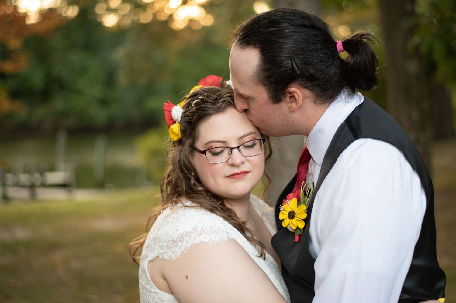 Bride and groom sharing a romantic kiss during sunset at Wye Island, a wedding venue on a budget