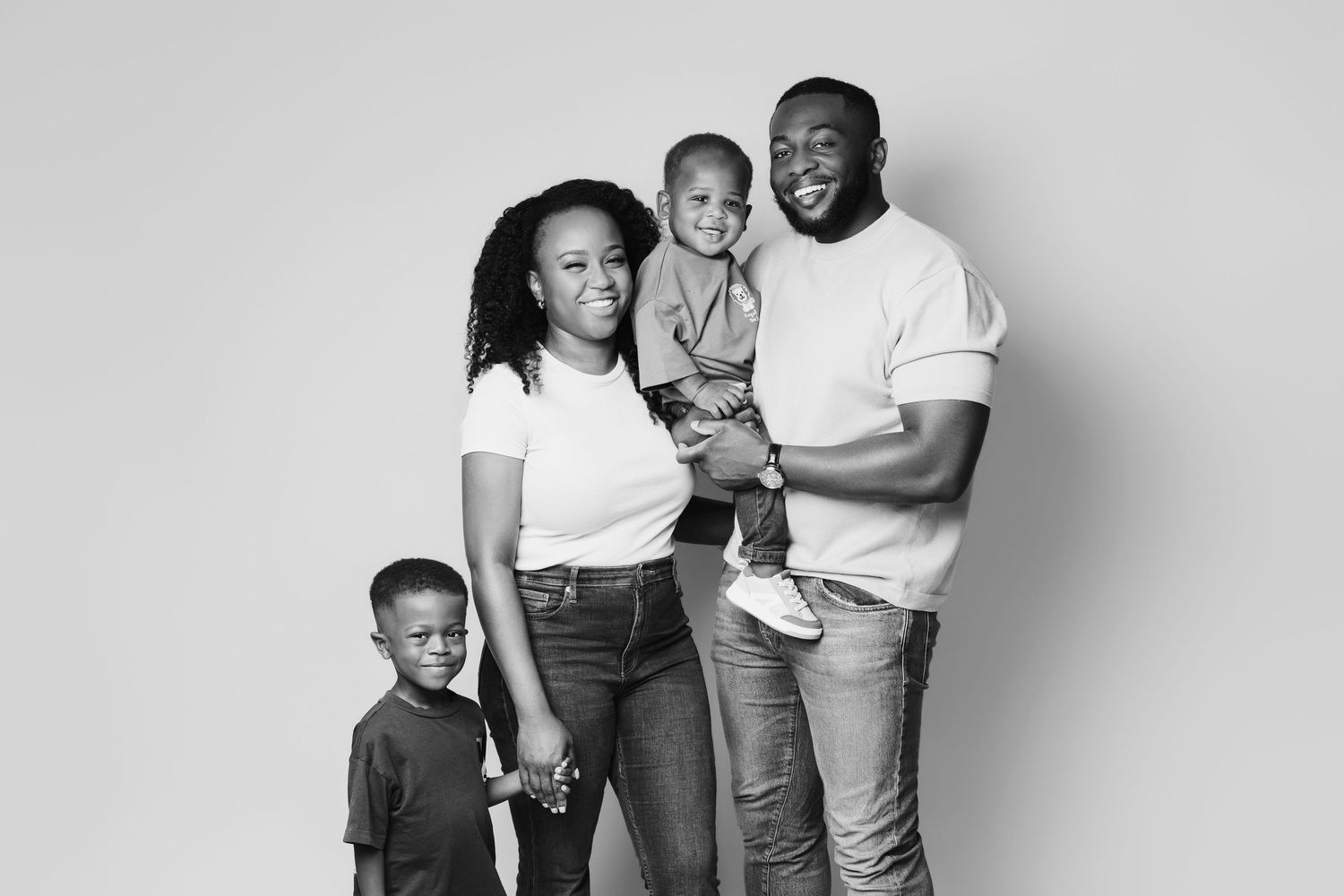 Black and white photo series showing family members in matching formal attire posing together against a studio backdrop.