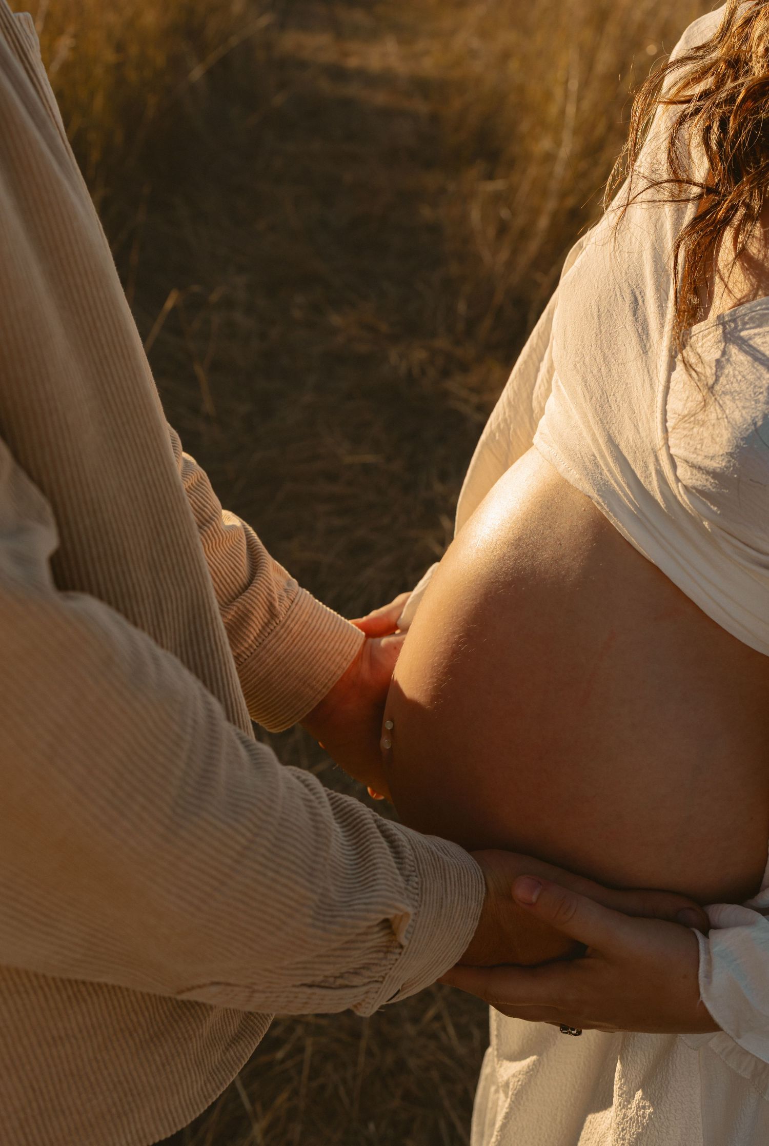 Multiple frames show a person's hand holding and extending in a warm sunset lighting against a dark background.