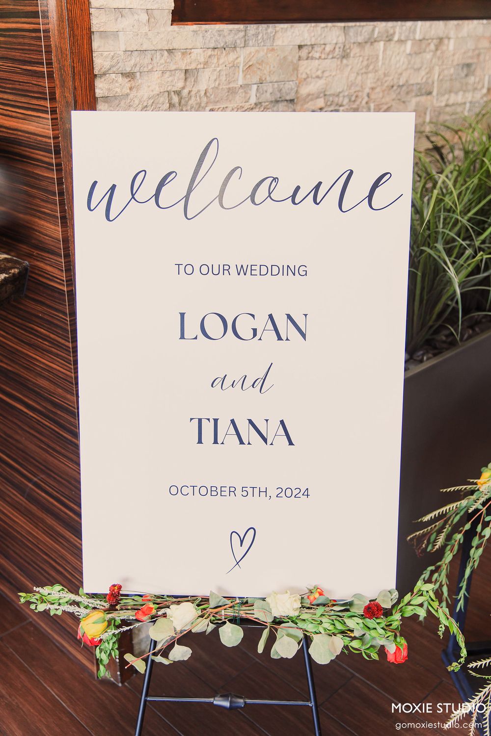 Wedding welcome signs with blue calligraphy text and floral decorations.