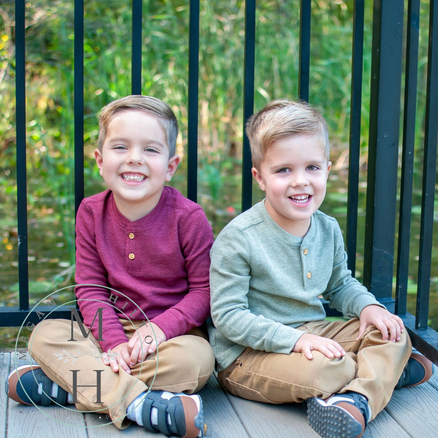 photo of twin boys next to fence and pond