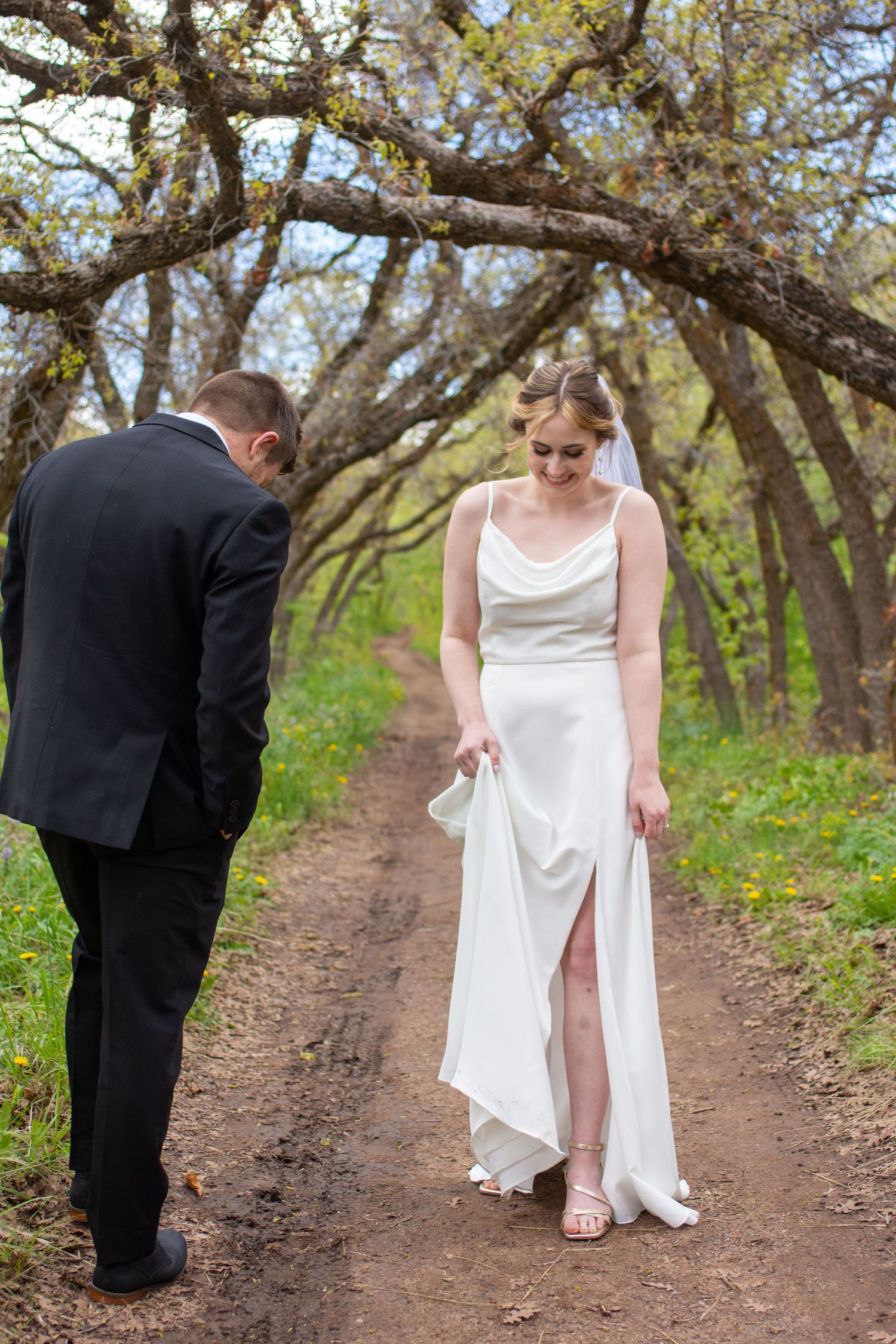 Groom and bride laughing shyly in Salt Lake City, Utah.