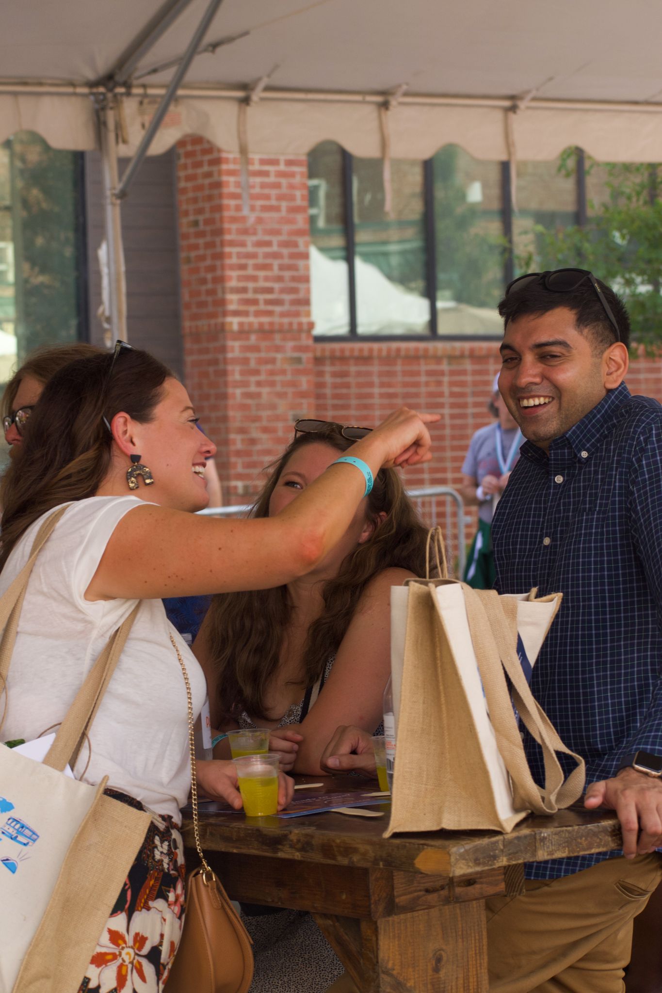 People sharing a lighthearted moment at an outdoor market or festival.