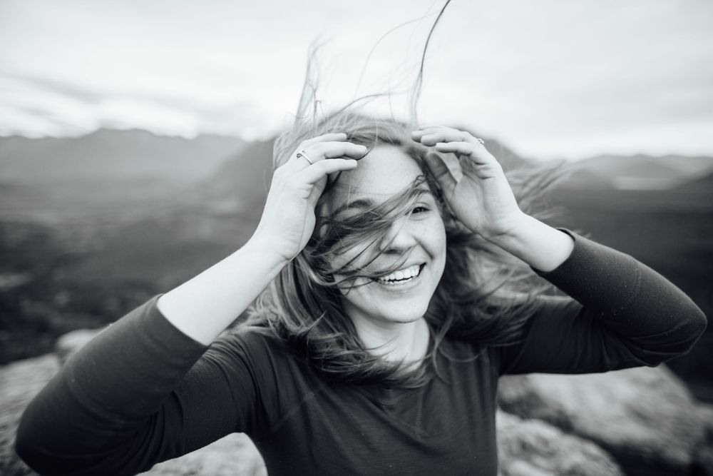 Black and white image of woman with windswept hair on Rattlesnake Ledge, scenic Washington hike