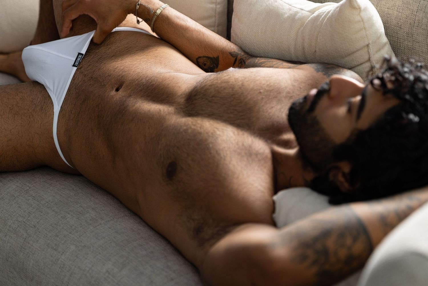 Photo of a man in underwear in a field of flowers captured by Los Angeles boudoir photographer.