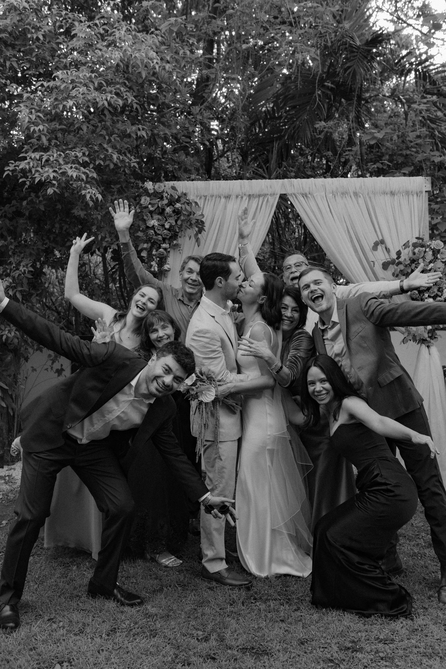 Black and white photo of a couple sharing a tender embrace at a wedding ceremony.