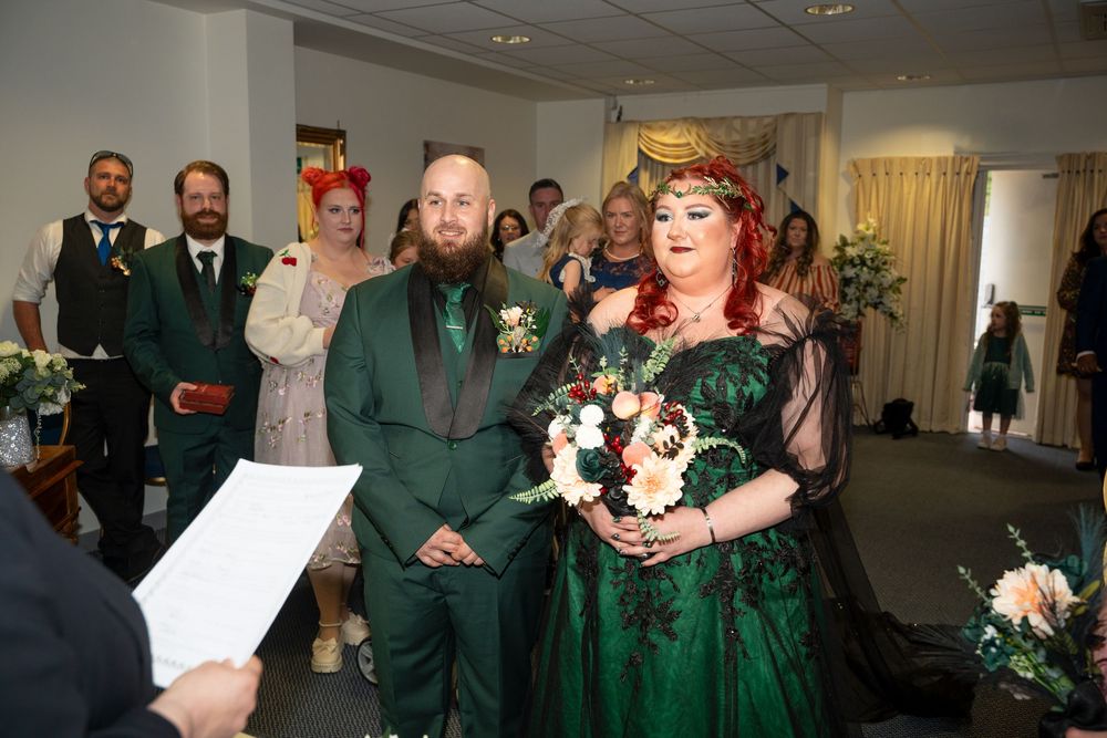 Couple in matching green wedding attire walk down the aisle at their unique themed wedding ceremony.
