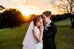Bride and groom share a romantic moment at sunset on a lush green golf course during their wedding at Indooroopilly Golf Club Brisbane QLD