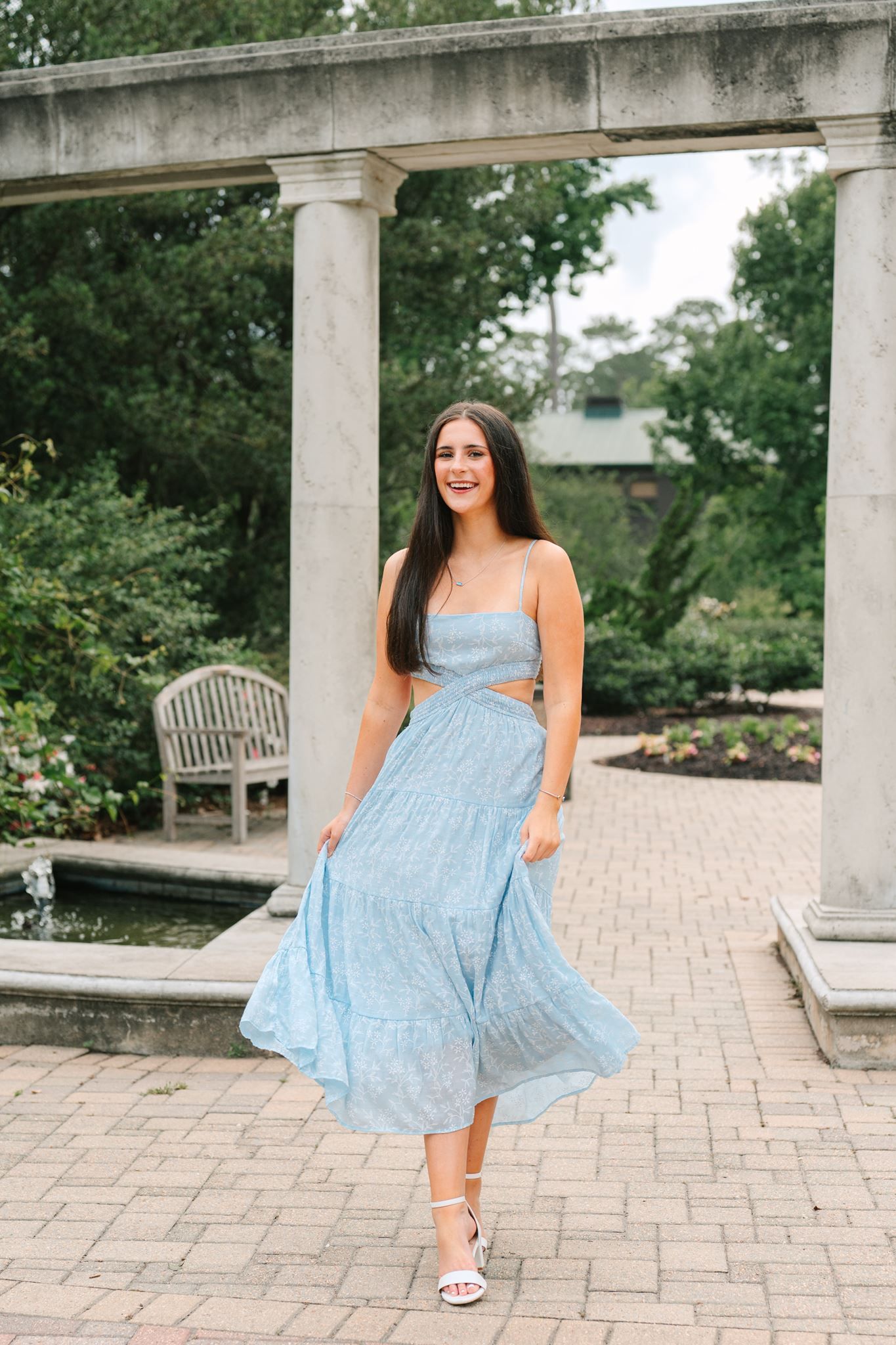 College Park High School senior girl, wearing long blue dress, at Mercer Botanic Garden in Spring Texas.