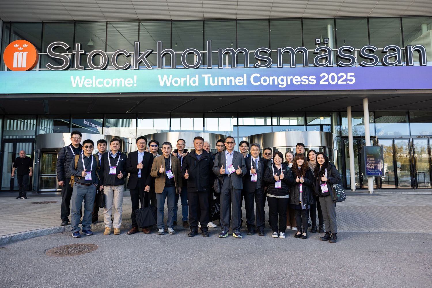 A group of delegates pose outside Stockholmsmassan venue at the World Tunnel Congress 2025.