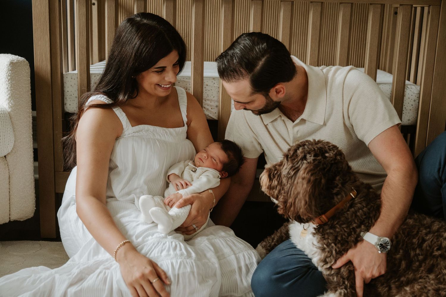 Parents holding their newborn baby during a relaxed in-home lifestyle newborn photography session in New Jersey.