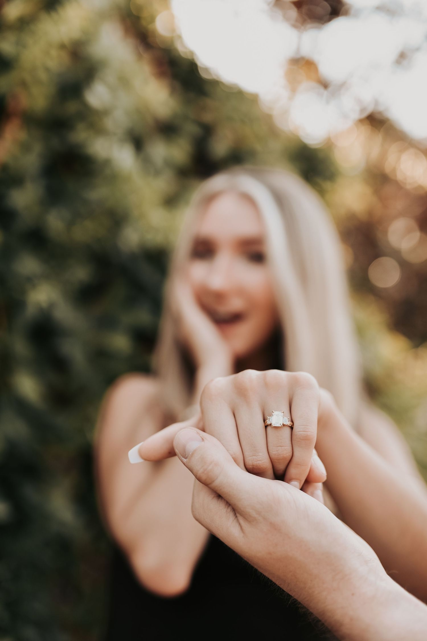 Newly engaged couple holding hands after their proposal