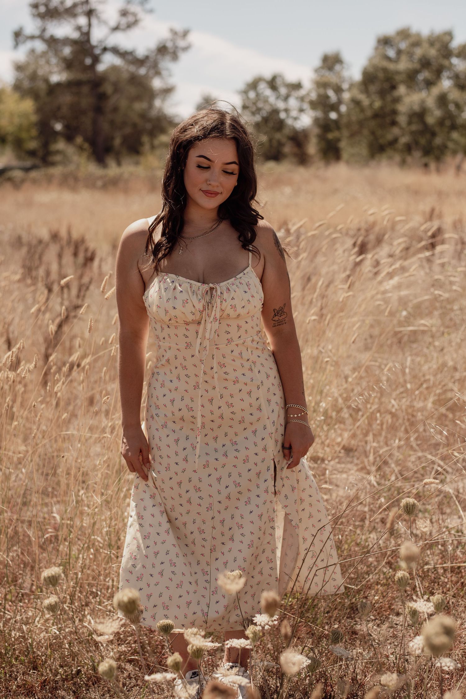 A senior wandering through an open Sonoma County field, capturing their personality against golden grass, soft light, and wide-open skies.