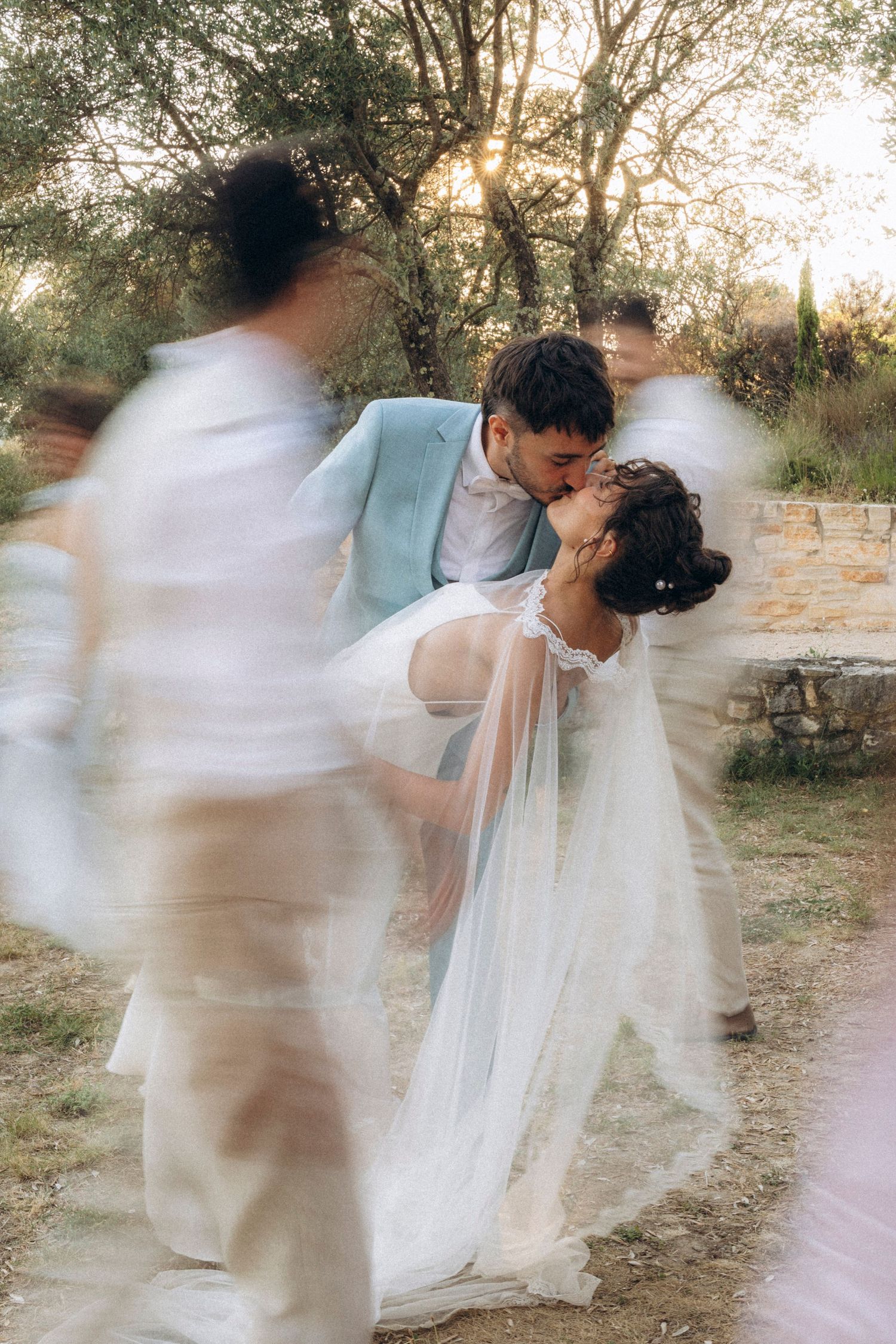 A tender autumn embrace captured during a wedding photoshoot with fall foliage.