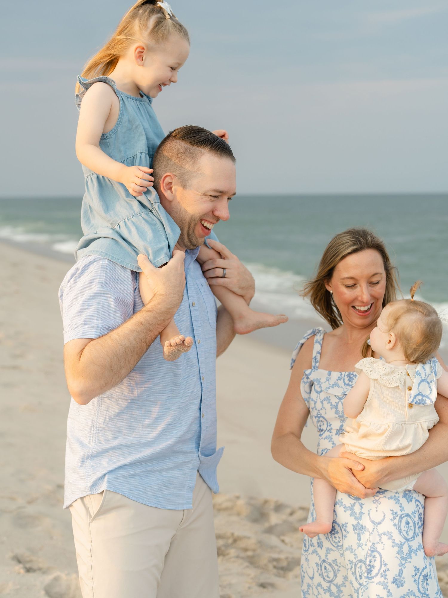 Family of four playing along the coast during golden hour in Brick, NJ.
