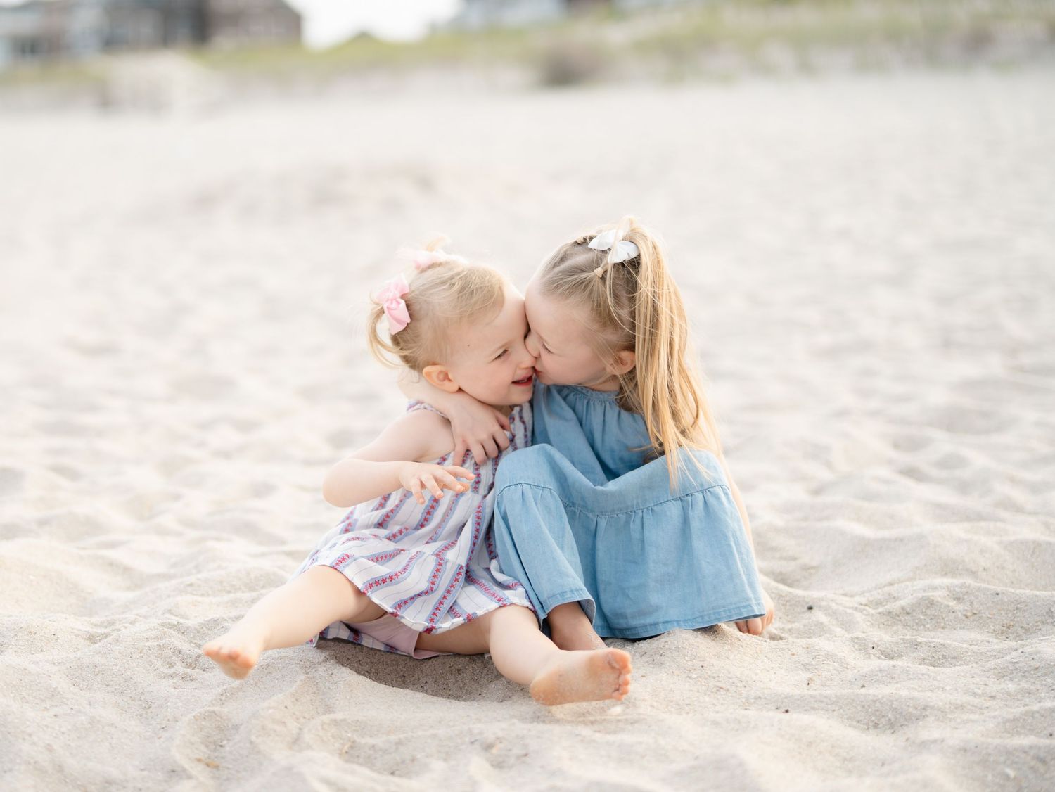Candid photography of young cousins playing in the sand at a Mantoloking family photo session.