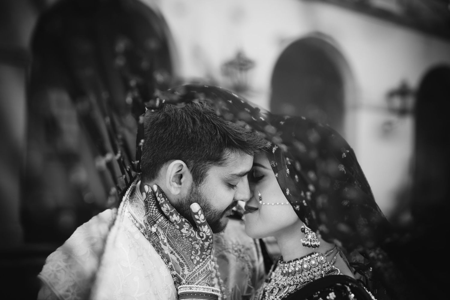 Emotional Indian wedding moment at Richmond Marriott—bride and groom share an intimate embrace in stunning black and white.
