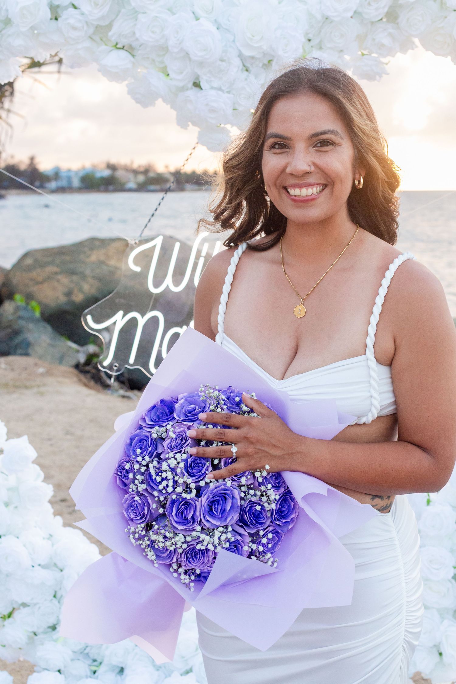 Marriage proposal. Portrait of the woman with her ring and bouquet of purple roses. Río Grande, Puerto Rico.