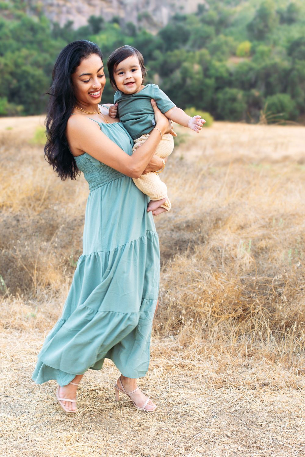 Mother holding her young child during an outdoor family photography session in Los Angeles.