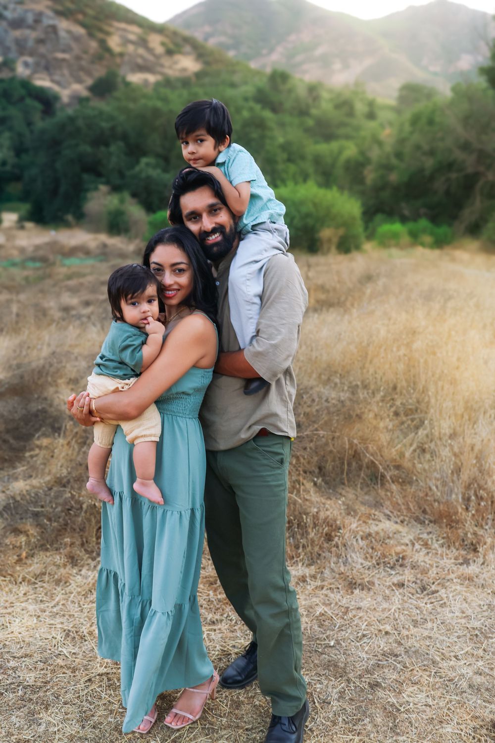 Parents holding their children during an outdoor family photography session in Los Angeles.