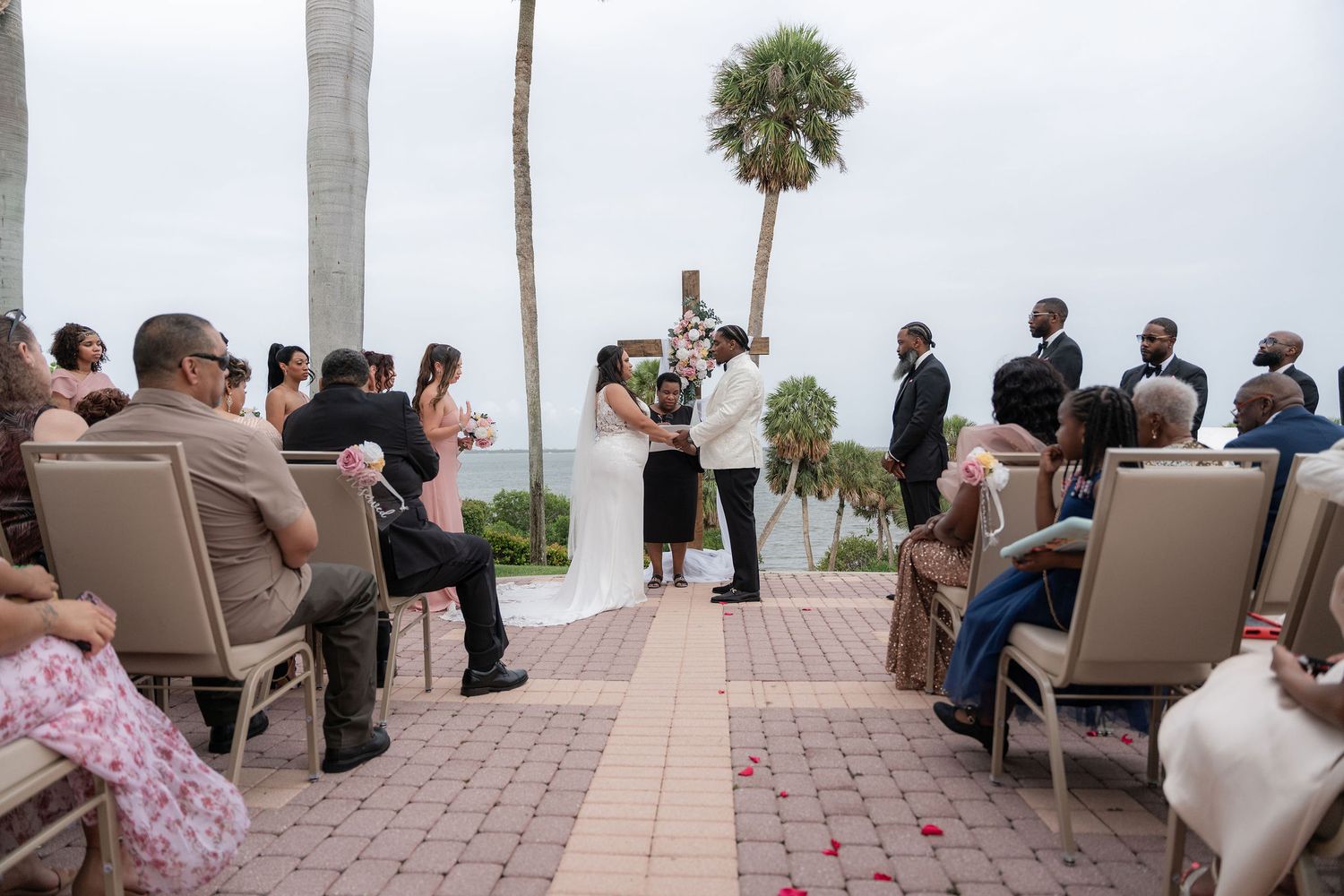 Wedding ceremony on the front patio at the Mansion at Tuckahoe with the Indian River behind the couple