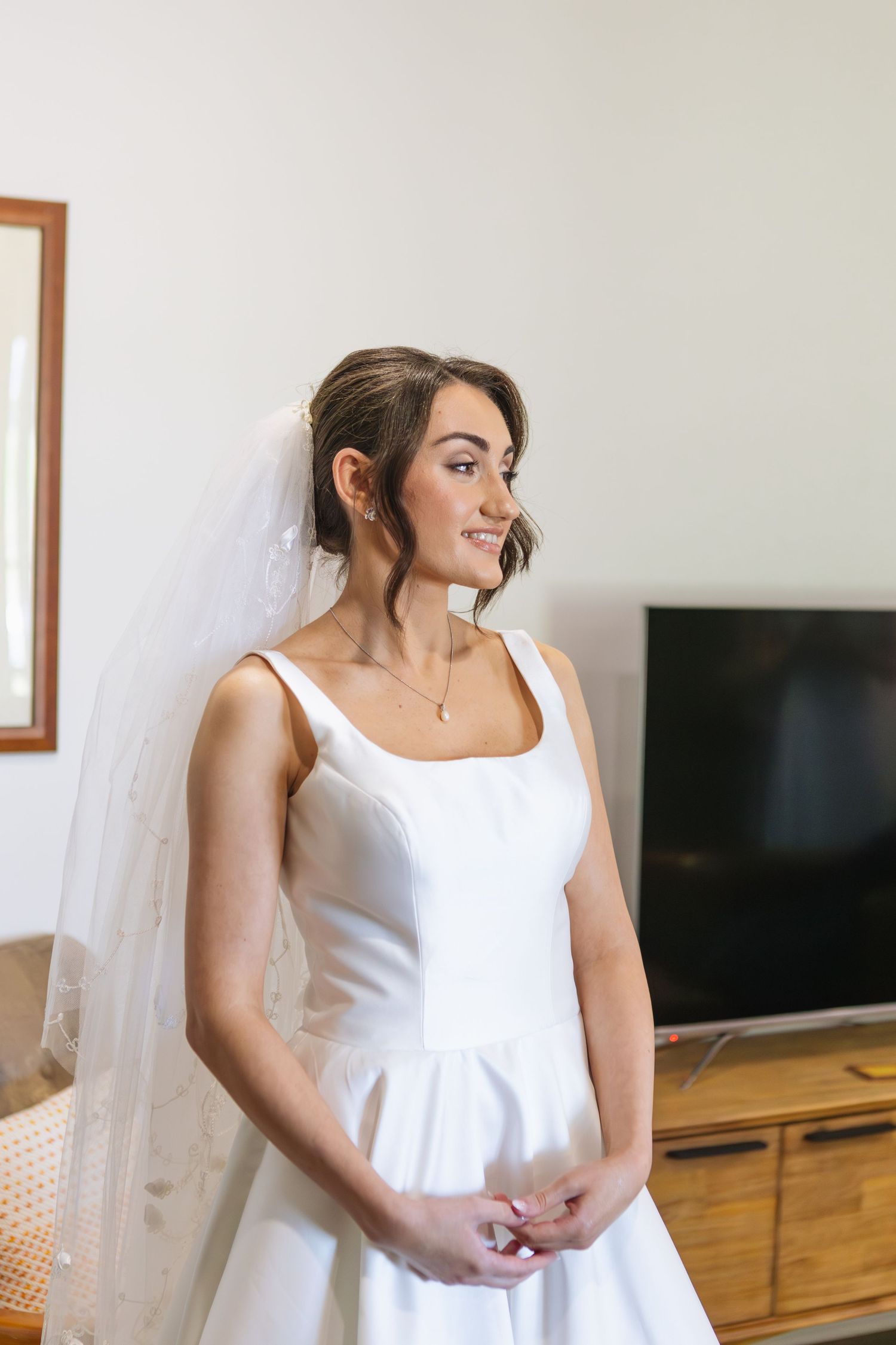 Close up of bride in wedding dress smiling looking to the side at two rivers winery wedding denman