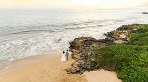 Maui wedding photographer photo against beautiful Maui sunset beach by ohwowfotos.
