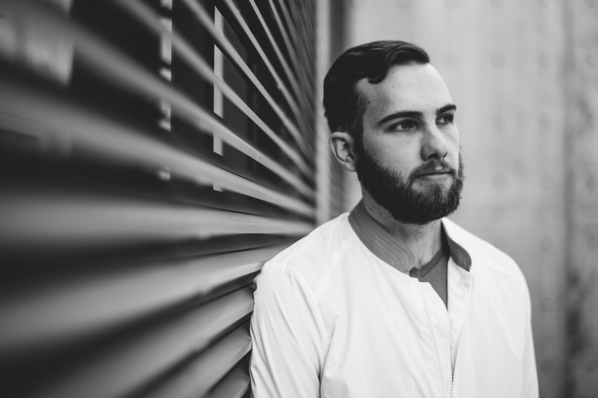 headshot of designer Kevin Craft, man with beard, in sculpture garden, art's district, dallas texas