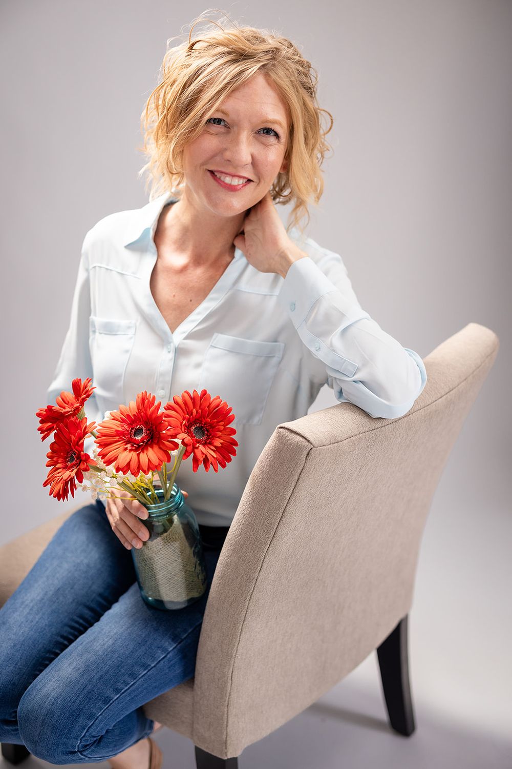 Studio personal branding portrait of a real estate agent holding flowers at Michele McCoy's studio in Mountain Home, Arkansas