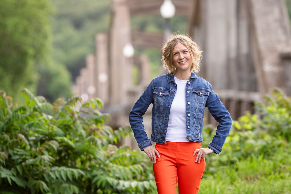 Real estate agent in a denim jacket during a personal branding session near the Cotter Bridge in Cotter, Arkansas