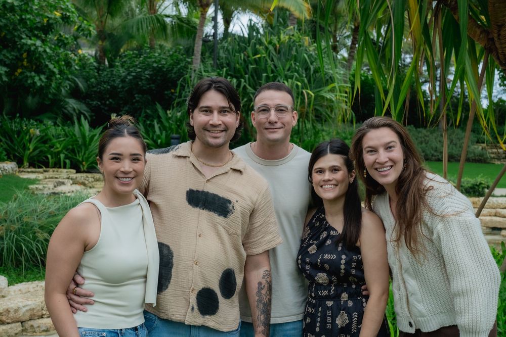 Family portrait of cousings in a garden setting.