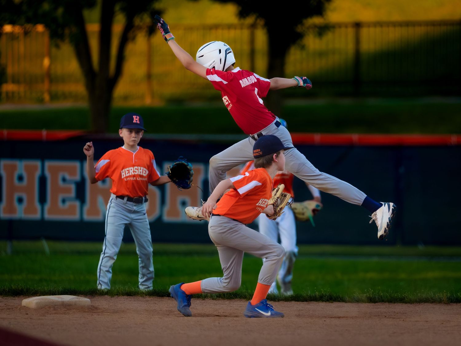 Hershey Little League players colliding at second base during league championships, by Deanna Fox, SportsFox Photography, Hershey PA