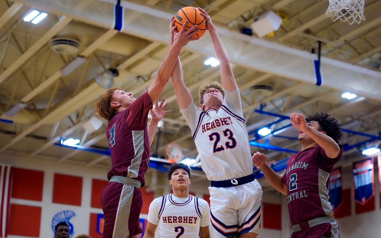Hershey #23 grabbing a rebound over Manheim Central, PIAA Districts round one, by Deanna Fox, SportsFox Photography based in Hershey PA