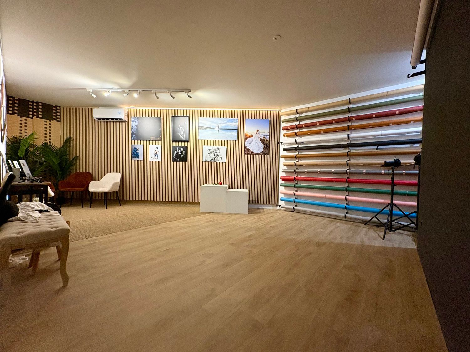 Modern surf shop showroom with colorful surfboards displayed on wall rack, hardwood floors, and minimalist decor.