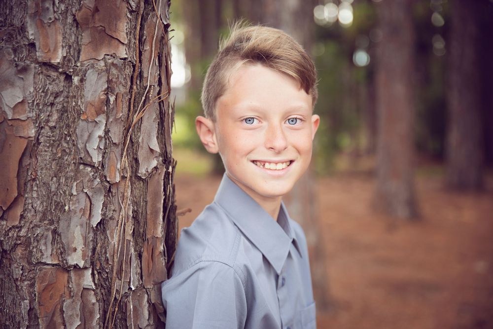 boy smiling at the camera for his family session