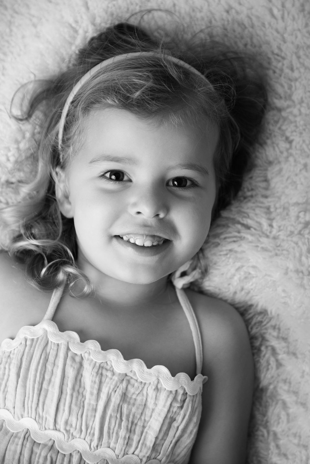 big sister with her stunning smiles during her sisters newborn session